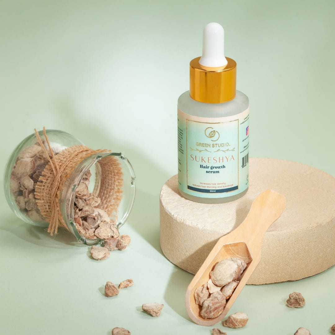 Stylized image of Hair Growth Ayurvedic serum from Green Studio Ayurveda with some natural ingredients as props