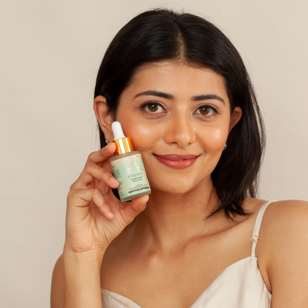 Madhuyashti Ayurvedic face serum being held by a model showcasing radiant skin
