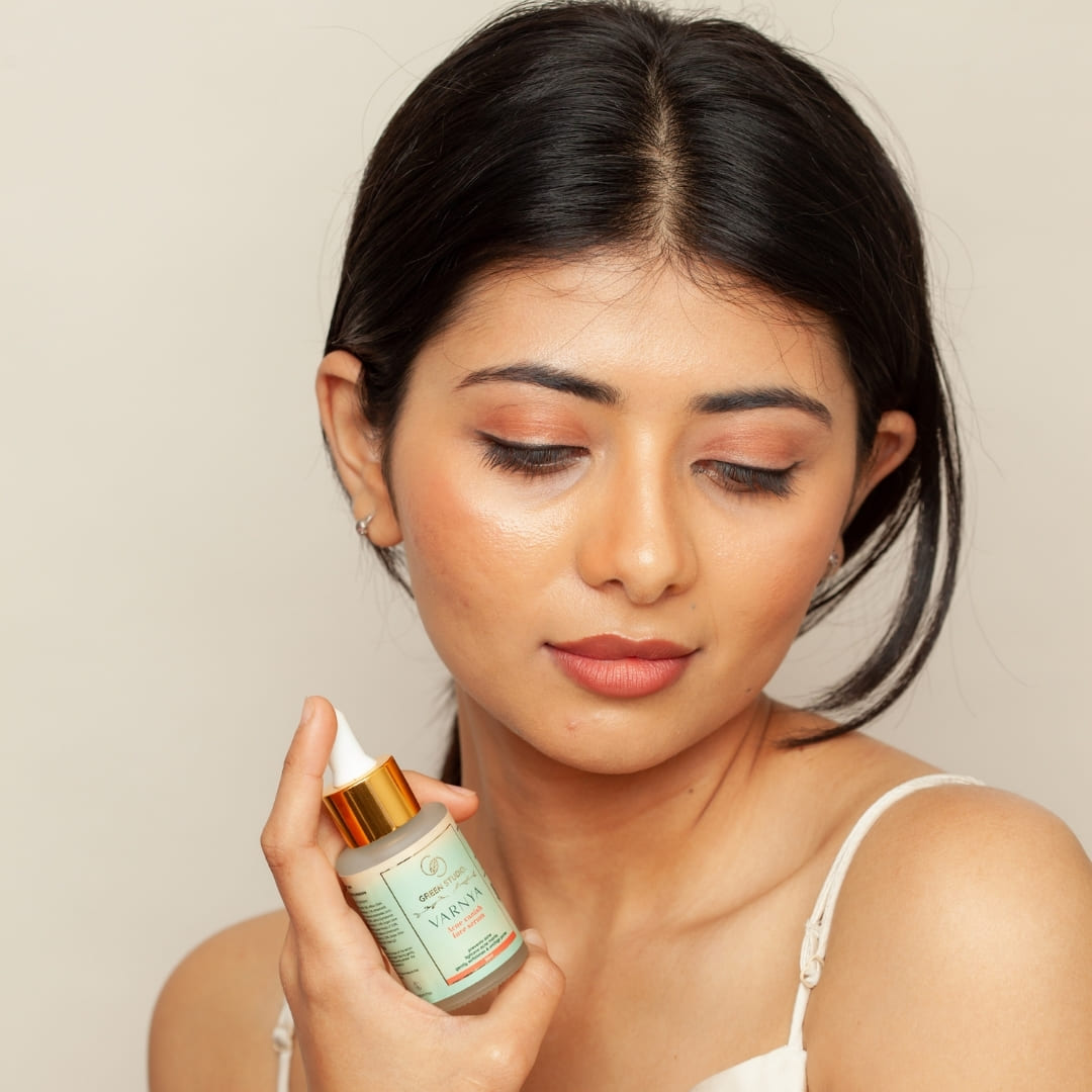 Acne vanish Ayurvedic face serum being held by a model showcasing radiant skin